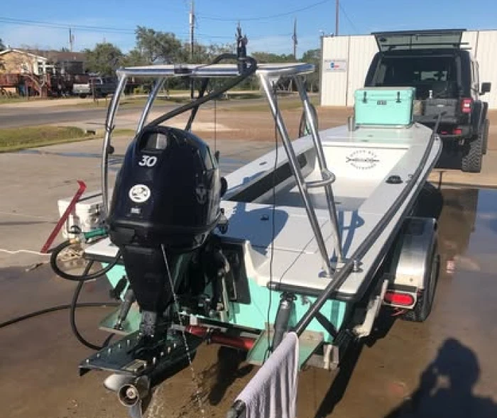 Boat on trailer with outboard engine.