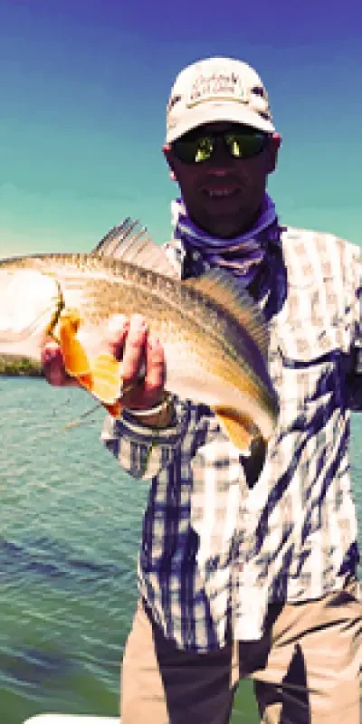 Person holding a fish on a boat in water.